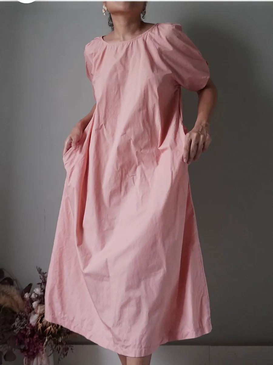 Peachy pink crisp cotton blend dress with slightly puffed sleeves and pockets at the sides - Image 1