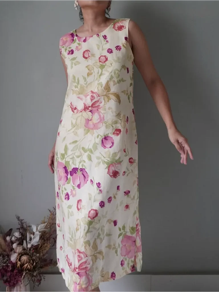 Fascinating linen dress with spring floral blooms pattern has discoloration