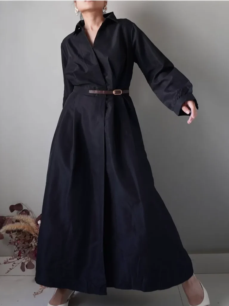 Black full dress with long sleeves and a belt accent