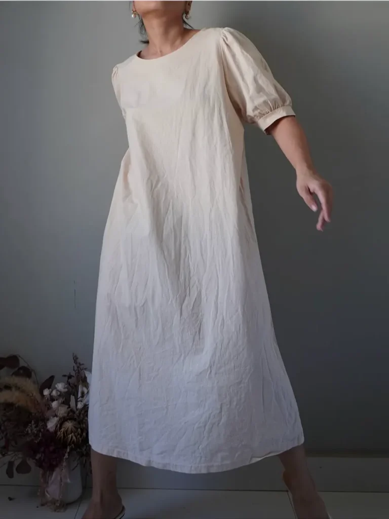 Very uncomplicated beige linen shift dress with subtle puffed sleeve details
