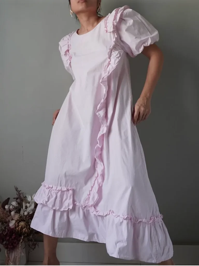 periwinkle dress with all the displaced ruffle details and puffed sleeves