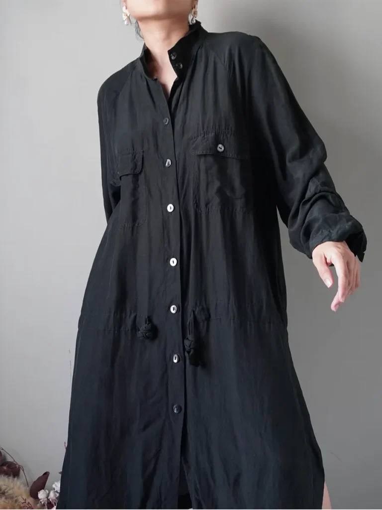 High-slit black dress with long sleeves and top pockets