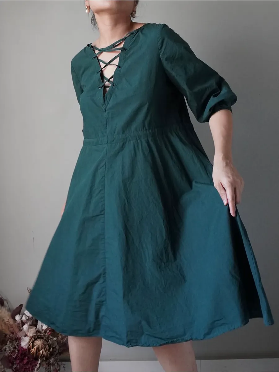 Solid seaweed green dress with crisscross details in front and drawstring at the back to cinch waist - Image 1