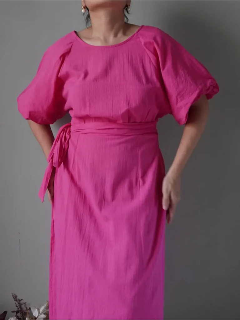Fuchsia pink cotton linen dress with elegant bell sleeves, self belted, has a back slit