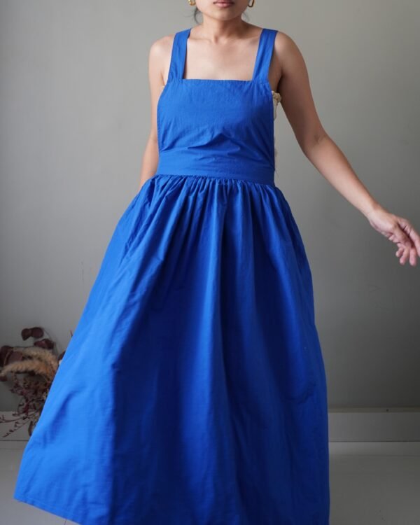 Solid crayola blue pinafore with pockets and crisscross back detail - Image 1