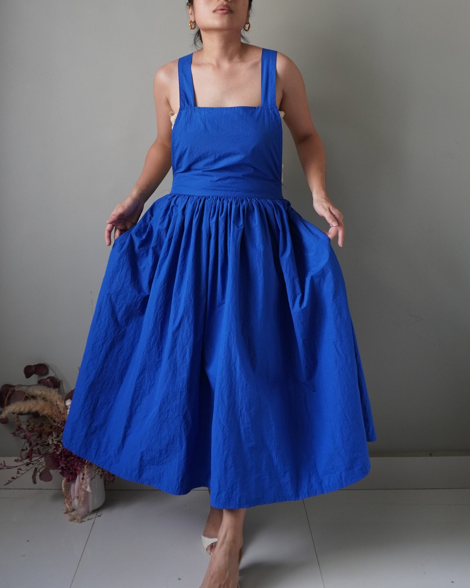 Solid crayola blue pinafore with pockets and crisscross back detail - Image 2