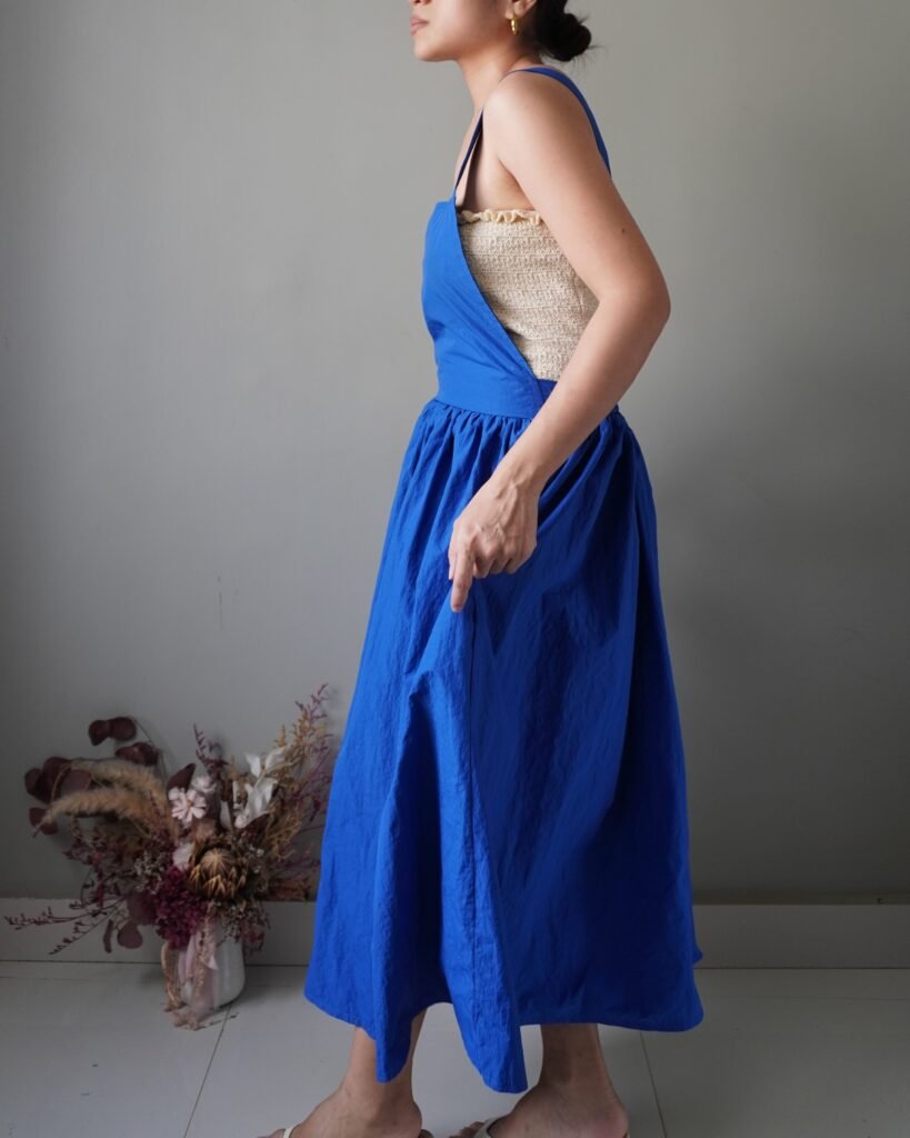 Solid crayola blue pinafore with pockets and crisscross back detail