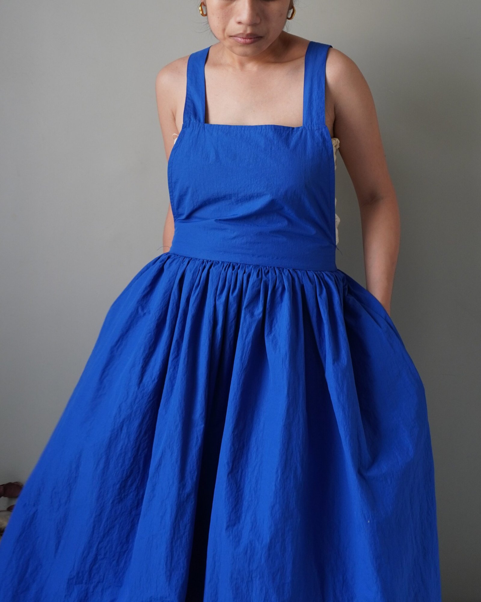 Solid crayola blue pinafore with pockets and crisscross back detail - Image 5