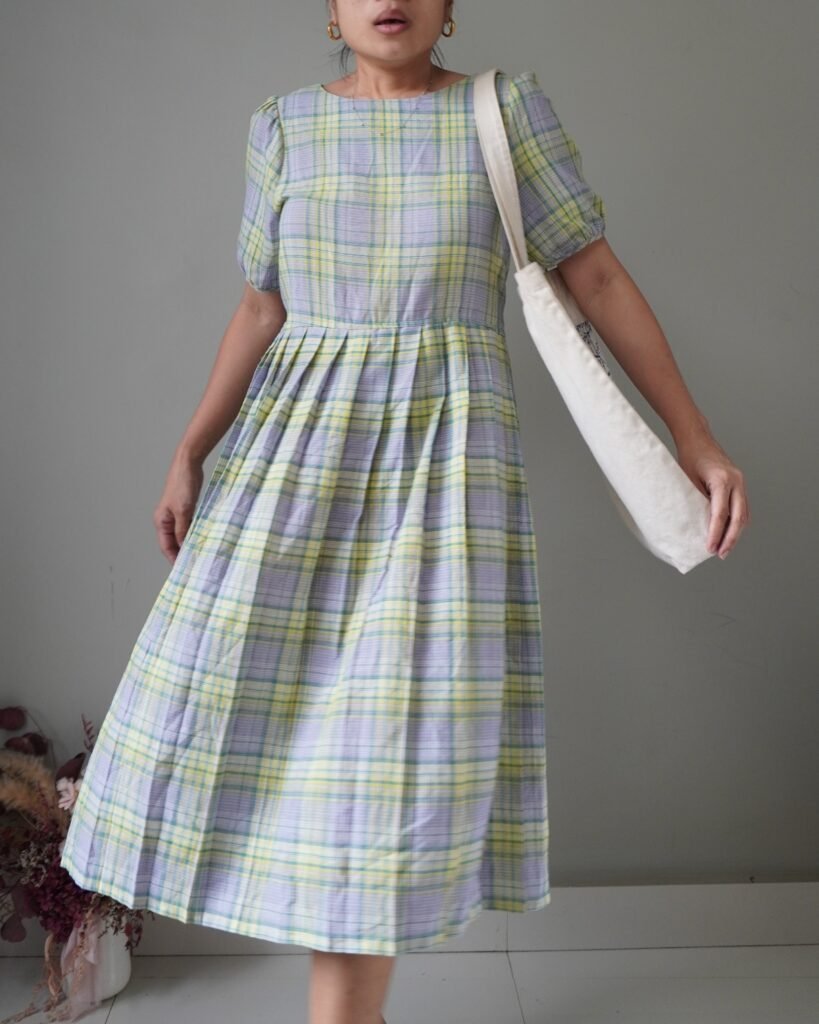 A beautiful pleated colorway country dress with a self tie ribbon