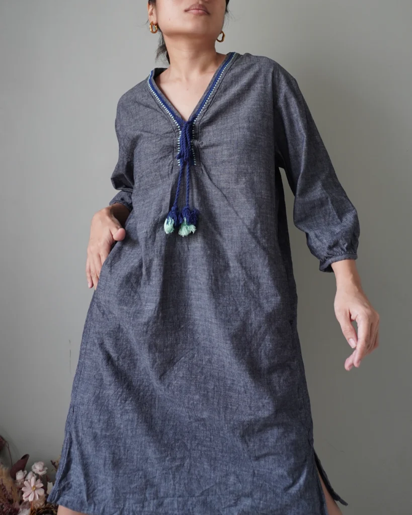 a bluish gray linen casual dress with functional pockets and the prettiest tassel deets