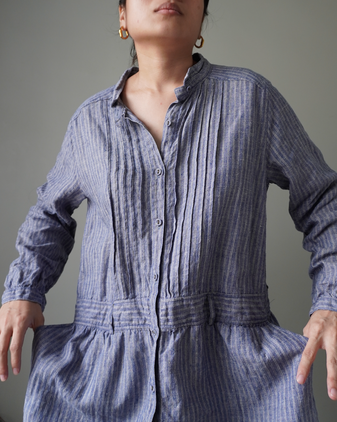 Blue striped pattern dress with button down details, cozy long sleeves and pleat accents - Image 1