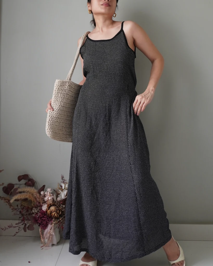 Black polka patterned dress with back zipper and ribbon that ties to the back, has few removed hems that’s reworkable