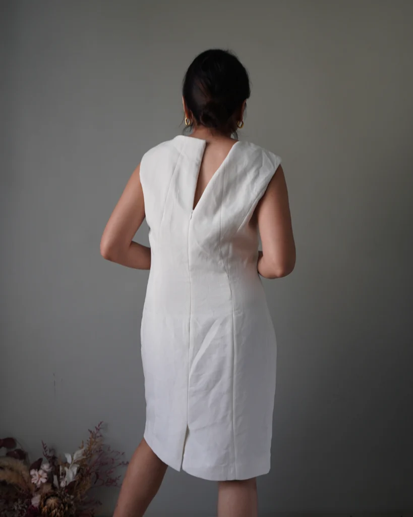 Elevated with pleat accents, edgy white sleeveless dress with zipper at the back