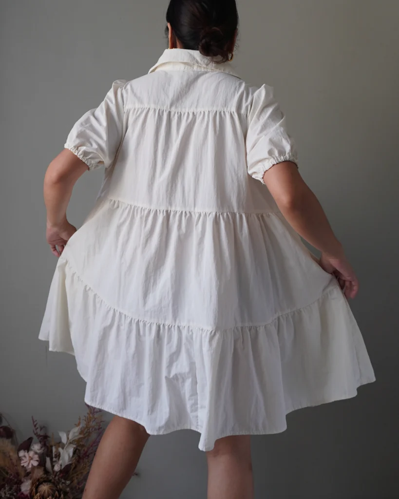 Cream babydoll button down dress with tiered details, shape-friendly